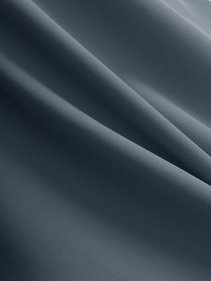 Close-up texture of grey blue flat front golf joggers pants with belt loops fabric showing detailed material and weave.