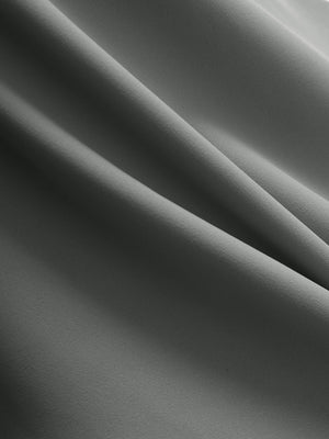Close-up texture of iron grey flat front golf joggers pants with belt loops fabric showing detailed material and weave.