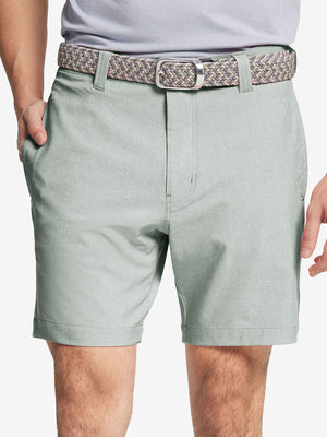 Front view of youth wearing glacier grey Heather Performance Golf Shorts, showing fit and style