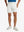 WHITE 4-way Stretch Performance Solid Shorts, golfer front lower body with club, 7 Inch view
