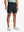BLACK 4-way Stretch Performance Solid Shorts, golfer front lower body with club, 7 Inch view