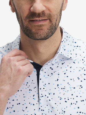 Front view from nose to chest of model wearing the blue navy dot 4 way stretch print collared polo shirt, showcasing the upper fit