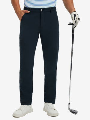 Lightweight moisture wicking dress pants in navy, front lower-body with model leaning on golf club.