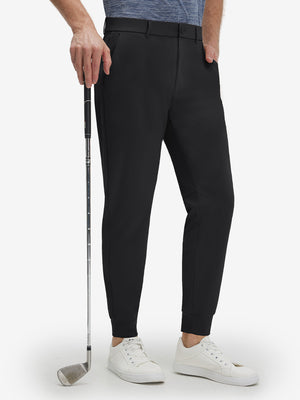 Front lower body shot of model wearing black flat front golf joggers pants with belt loops