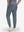 Back lower body shot of model wearing grey blue flat front golf joggers pants with belt loops