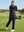 Texture heather fleece lined 1/4 zip pullover, golfer swinging in black on course, active pose