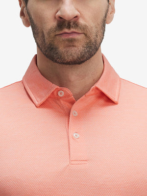 Front view from nose to chest of model wearing orange red grid ultra-light quick dry moisture wicking collared polo shirt