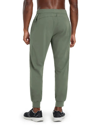 Back lower body view of model wearing OLIVE GREEN Performance Tapered Sports Joggers