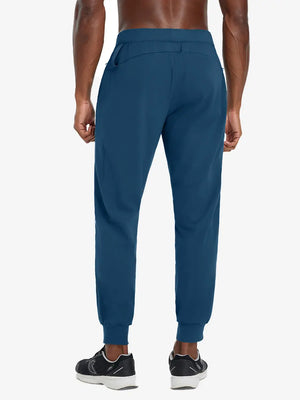 Back lower body view of model wearing BLUE INDIGO Performance Tapered Sports Joggers