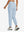 Model wearing women's stretch fleece lined water resistant joggers in light grayish blue, showing the back lower body view.
