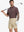 Half-body front view of model holding golf club wearing WINE RED FLOWER Popular Heather Print Polo
