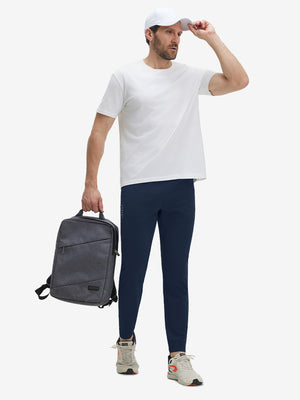 Model wearing navy superion softness mesh joggers with zipper pockets with a bag
