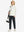 Boys Stretch Fleece Lined Casual Golf Pants in black, model front view carrying tennis bag