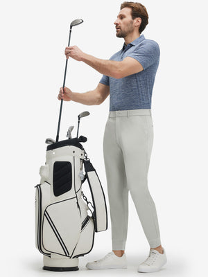 Front full body shot of model wearing silver gray flat front golf joggers pants with belt loops