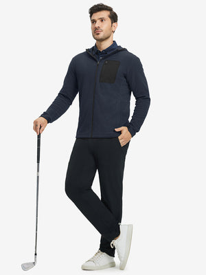 Model holding golf club, dressed in full zip fleece hoodied jacket in navy, sporty and casual.