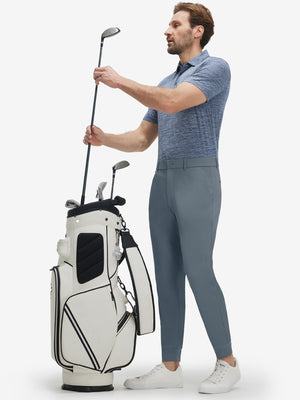 Front full body shot of model wearing grey blue flat front golf joggers pants with belt loops