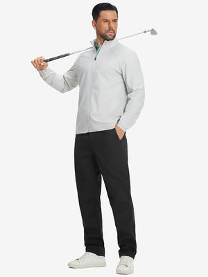 Full-body shot of model holding a golf club while wearing black thermal water repellent fleece dress pants