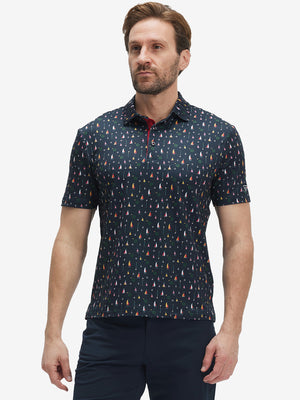 Front half-body shot of model wearing the colorful sailboat 4 way stretch print collared polo shirt for a casual sporty look