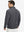 Back upper view of model in midweight warm stretchy quarter zip pullover, highlighting shoulder fit in grey.