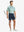 NAVY 4-way Stretch Performance Solid Shorts, golfer full-body front with club, 7 Inch length