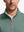 Front shot from nose to chest of model wearing dark green melange lightweight sleeveless quarter zip golf vest