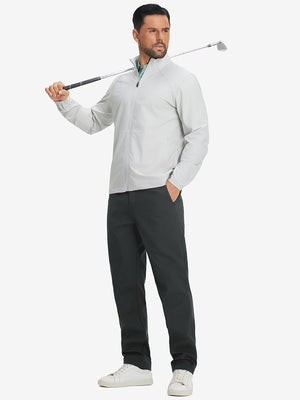 Full-body shot of model holding a golf club while wearing grey thermal water repellent fleece dress pants