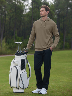 Full body model on golf course wearing classic heather pullover hoodies with 2 pocket, brown melange