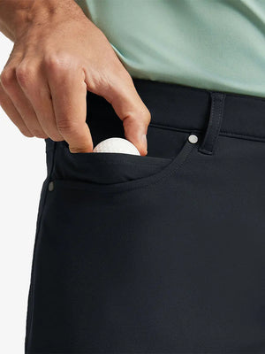 BLACK 4-way Stretch Performance Solid Shorts, front pocket holding golf ball detail, 7 Inch