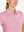 Close-up front view from nose to chest in PINK Women's Performance Solid Polo