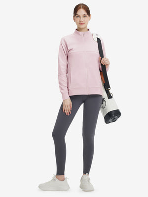 Women's Water-Resistant Stretch Fleece Lined Jacket in light purple, model holding golf bag