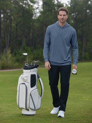 Model holding golf ball beside golf bag in classic heather pullover hoodies with 2 pocket, navy melange
