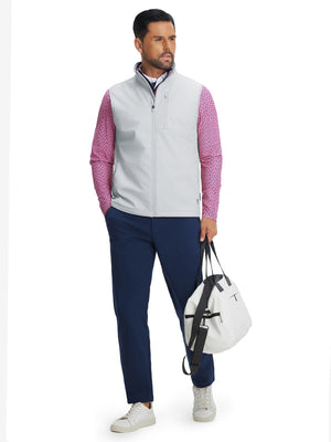 Full-body shot of model holding golf bag while wearing sleeveless softshell fleece outdoor vests with 6 pockets in light gray