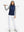 Model holding golf club full body, women's lightweight slim-fit puffer vest styled in sporty navy