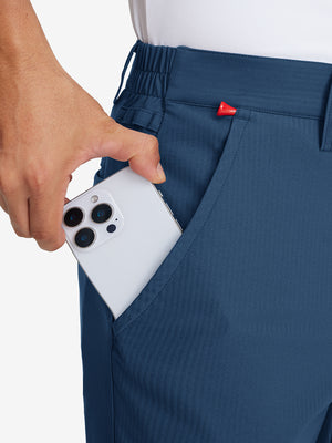 Hand placing an iPhone into pocket of lightweight flat front casual trousers in blue indigo.