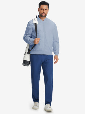 Model carrying golf bag in casual windproof bomber jacket, sporty look in slate blue