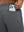 Close-up of iPhone partly inside pocket of grey heather soft sweatpants with 4 zipper pockets