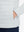 Detail view of outer pocket on light grey heather warm puffer winter golf jacket