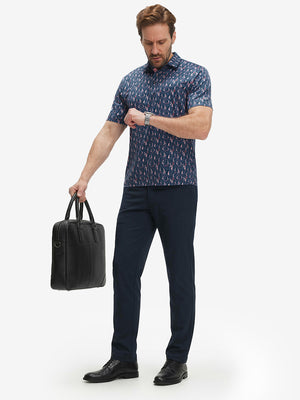 Full-body front view of model wearing the navy sailboat 4 way stretch print collared polo shirt, showing the complete outfit