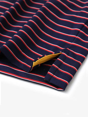 Hem slit detail of NAVY/RED STRIPE Youth Performance Golf Polo highlighting stitching and finish.