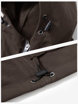 Close-up of zipper and button details on reflective hooded softshell jacket in coffee brown.