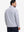 Back upper body angle of the colorful hexagon full print quarter zip pullover, model turns head slightly.