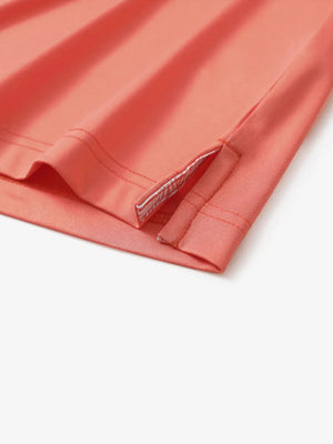 Close-up of side slit detail on the Melon Everyday Classic Solid Polo hem