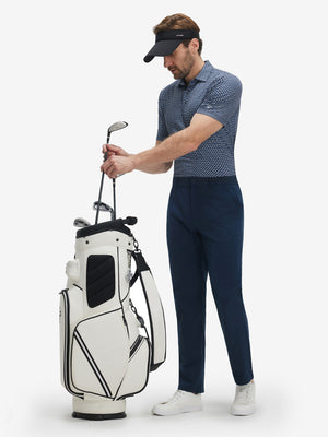 Model taking club from golf bag in Performance quick dry print golf polos with dynamic blue white stars