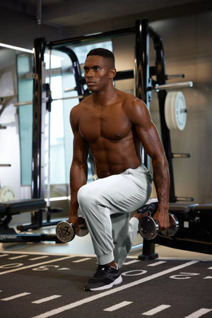 Full-body view of model in gym wearing GLACIER GREY Performance Tapered Sports Joggers