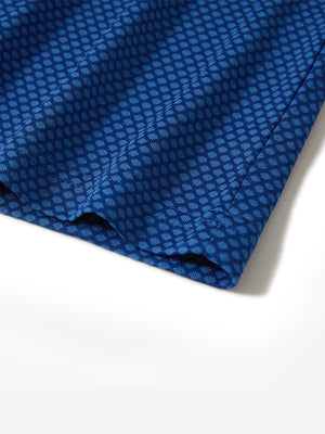 Hem detail of jacquard quarter zip pullover in cobalt, focusing on stitching and side vent finish.