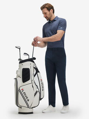 Full-body front view of model wearing the dark blue golf club 4 way stretch print collared polo shirt, showing the complete outfit