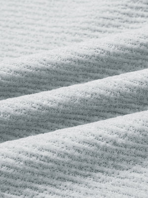 Close-up of fabric on texture solid hoodies pullover, showing texture and finish in light grey heather.