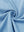 Close-up of melange fabric on quarter zip pullover, showing texture and detail in light blue melange.
