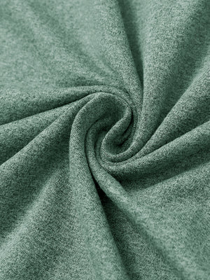 Close-up of melange fabric on quarter zip pullover, showing texture and detail in dark green melange.