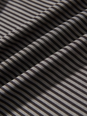 Texture close-up of Kids stripe golf polos with soft fabric and bright black stripe stripes